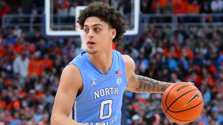 Feb 21, 2026; Syracuse, New York, USA; North Carolina Tar Heels guard Kyan Evans (0) controls the ball during the first half against the Syracuse Orange at the JMA Wireless Dome. Mandatory Credit: Rich Barnes-Imagn Images