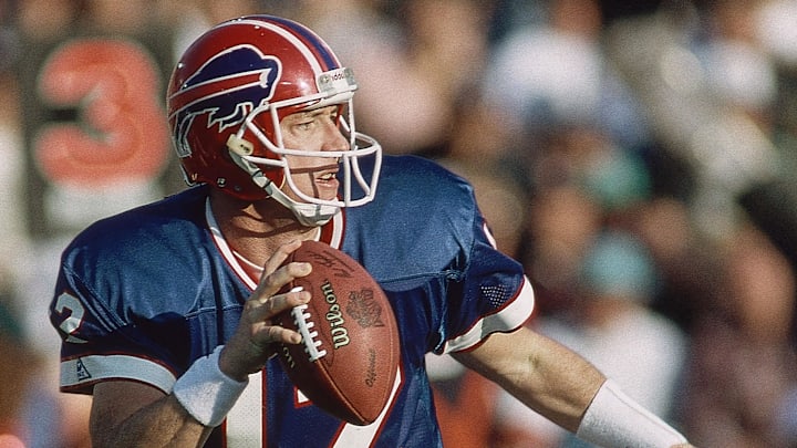 Jan 31, 1993; Buffalo Bills quarterback Jim Kelly scrambles with the ball against the Dallas Cowboys during Super Bowl XXVII at the Rose Bowl. The Cowboys defeated the Bills 52-17.