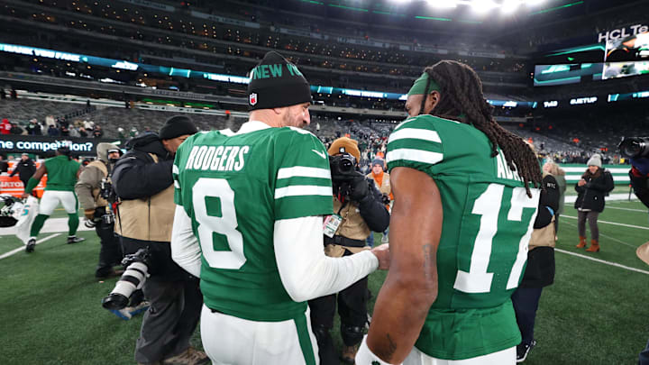 Jan 5, 2025; East Rutherford, New Jersey, USA; New York Jets quarterback Aaron Rodgers (8) and wide receiver Davante Adams (17) walk on the field after the Jets win over the Miami Dolphins at MetLife Stadium. Mandatory Credit: Ed Mulholland-Imagn Images