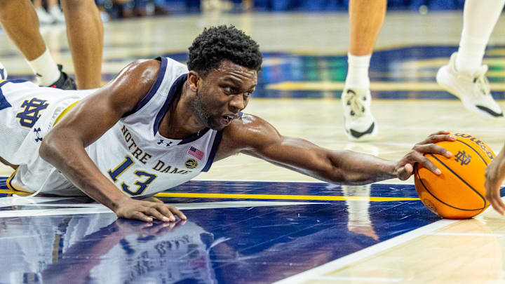 Feb 28, 2026; South Bend, Indiana, USA; Notre Dame Fighting Irish guard Sir Mohammed (13) dives for a loose ball against the NC State Wolfpack during the first half at Purcell Pavilion at the Joyce Center. 