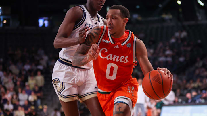 Mar 4, 2025; Atlanta, Georgia, USA; Miami Hurricanes guard Matthew Cleveland (0) is defended by Georgia Tech Yellow Jackets forward Darrion Sutton (10) in the first half at McCamish Pavilion. Mandatory Credit: Brett Davis-Imagn Images