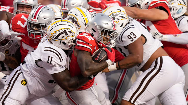 Sep 7, 2024; Columbus, Ohio, USA; Ohio State Buckeyes running back TreVeyon Henderson (32) muscles his way into the endzone for a touchdown past Western Michigan Broncos defensive lineman Anterio Thompson (11) and defensive lineman Corey Walker (93) during the first half of the NCAA football game at Ohio Stadium.