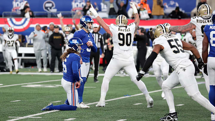 Dec 8, 2024; East Rutherford, New Jersey, USA; New York Giants place kicker Graham Gano (9) reacts after missing a potential game-tying field goal as New Orleans Saints defensive tackle Bryan Bresee (90) celebrates late during the fourth quarter at MetLife Stadium.  
