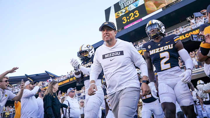 Sep 7, 2024; Columbia, Missouri, USA; Missouri Tigers head coach Eli Drinkwitz runs out with the team against the Buffalo Bulls prior to a game at Faurot Field at Memorial Stadium. Mandatory Credit: Denny Medley-Imagn Images