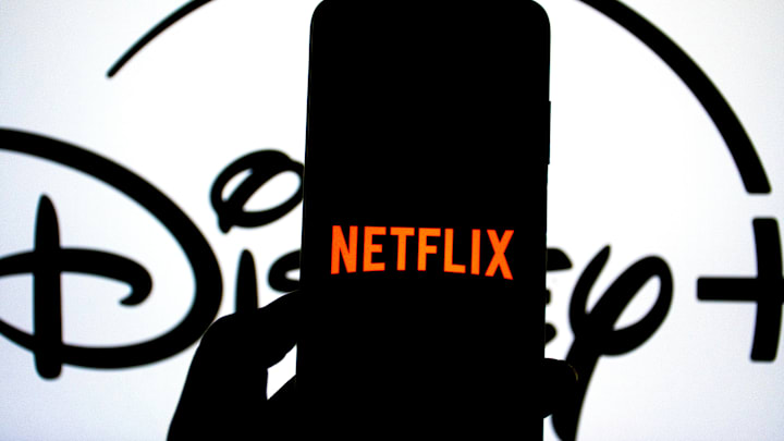 In this photo illustration, a Netflix logo seen displayed on...