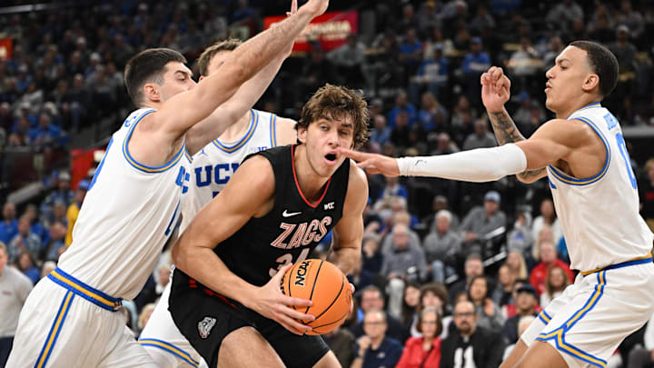 Dec 28, 2024; Inglewood, California, USA; UCLA Bruins forward Tyler Bilodeau (34) and guard Kobe Johnson (0) trap Gonzaga Bulldogs forward Braden Huff (34) during the second half at Intuit Dome. Mandatory Credit: Robert Hanashiro-Imagn Images Dec 28, 2024; Inglewood, California, USA; UCLA Bruins forward Tyler Bilodeau (34) and guard Kobe Johnson (0) trap Gonzaga Bulldogs forward Braden Huff (34) during the second half at Intuit Dome. Mandatory Credit: Robert Hanashiro-Imagn Images