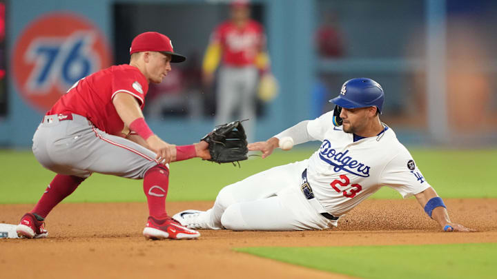 Aug 27, 2025; Los Angeles, California, USA;  Los Angeles Dodgers left fielder Michael Conforto (23) steals second base under the tag of Cincinnati Reds second baseman Matt McLain (9)  in the sixth inning at Dodger Stadium. Mandatory Credit: Kirby Lee-Imagn Images