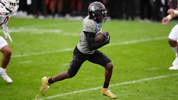 Nov 16, 2024; Boulder, Colorado, USA; Colorado Buffaloes wide receiver Travis Hunter (12) carries for a touchdown in the fourth quarter against the Utah Utes at Folsom Field. Nov 16, 2024; Boulder, Colorado, USA; Colorado Buffaloes wide receiver Travis Hunter (12) carries for a touchdown in the fourth quarter against the Utah Utes at Folsom Field.