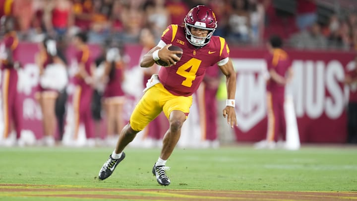 Aug 30, 2025; Los Angeles, California, USA; Southern California Trojans quarterback Husan Longstreet (4) carries the ball against the Missouri State Bears in the second half at United Airlines Field at Los Angeles Memorial Coliseum. Mandatory Credit: Kirby Lee-Imagn Images