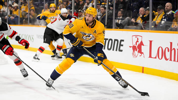 Feb 23, 2025; Nashville, Tennessee, USA;  Nashville Predators center Ryan O'Reilly (90) skates behind the net against the New Jersey Devilsduring the first half at Bridgestone Arena. Mandatory Credit: Steve Roberts-Imagn Images