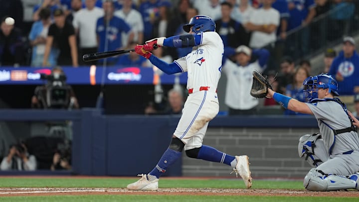 Ernie Clement hitting a double at Rogers Centre during game 7 of the World Series against the Dodgers