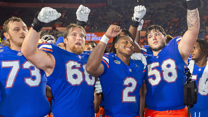 Florida Gators quarterback DJ Lagway (2) sings with Florida Gators offensive lineman Fletcher Westphal (68) and Florida Gators offensive lineman Austin Barber (58) at Ben Hill Griffin Stadium in Gainesville, FL on Saturday, September 7, 2024 after defeating the Samford Bulldogs 45-7. [Doug Engle/Gainesville Sun]