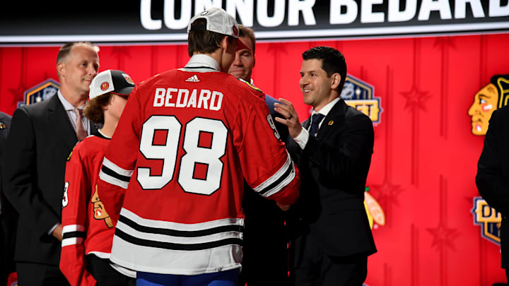 Jun 28, 2023; Nashville, Tennessee, USA; Chicago Blackhawks general manager Kyle Davidson congratulates first overall pick Connor Bedard during the 2023 NHL Draft at Bridgestone Arena. Mandatory Credit: Christopher Hanewinckel-Imagn Images Jun 28, 2023; Nashville, Tennessee, USA; Chicago Blackhawks general manager Kyle Davidson congratulates first overall pick Connor Bedard during the 2023 NHL Draft at Bridgestone Arena. Mandatory Credit: Christopher Hanewinckel-Imagn Images