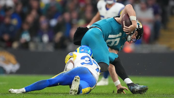 Oct 19, 2025; London, United Kingdom; Los Angeles Rams safety Quentin Lake (37) sacks Jacksonville Jaguars quarterback Trevor Lawrence (16) during the second half of an NFL International Series game at Wembley Stadium. Mandatory Credit: Kirby Lee-Imagn Images