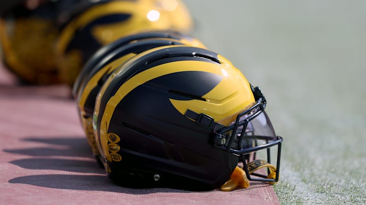 Sep 6, 2025; Norman, Oklahoma, USA; Michigan Wolverine helmets sit on the field near the sideline prior to a game against the Oklahoma Sooners at Gaylord Family-Oklahoma Memorial Stadium. Mandatory Credit: Kevin Jairaj-Imagn Images Sep 6, 2025; Norman, Oklahoma, USA; Michigan Wolverine helmets sit on the field near the sideline prior to a game against the Oklahoma Sooners at Gaylord Family-Oklahoma Memorial Stadium. Mandatory Credit: Kevin Jairaj-Imagn Images
