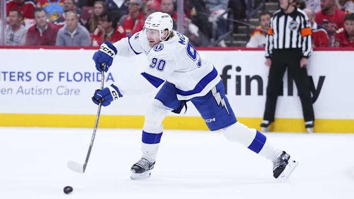 Apr 28, 2025; Sunrise, Florida, USA; iTampa Bay Lightning defenseman J.J. Moser (90) passes the puck against the Florida Panthers during the first period in game four of the first round of the 2025 Stanley Cup Playoffs at Amerant Bank Arena. Mandatory Credit: Rich Storry-Imagn Images