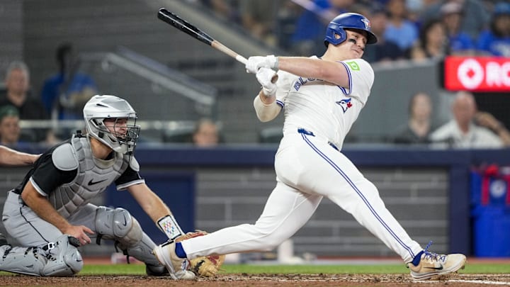Jun 22, 2025; Toronto, Ontario, CAN; Toronto Blue Jays outfielder Alan Roden (18) hits a triple against the Chicago White Sox during the seventh inning in their MLB game at Rogers Centre.