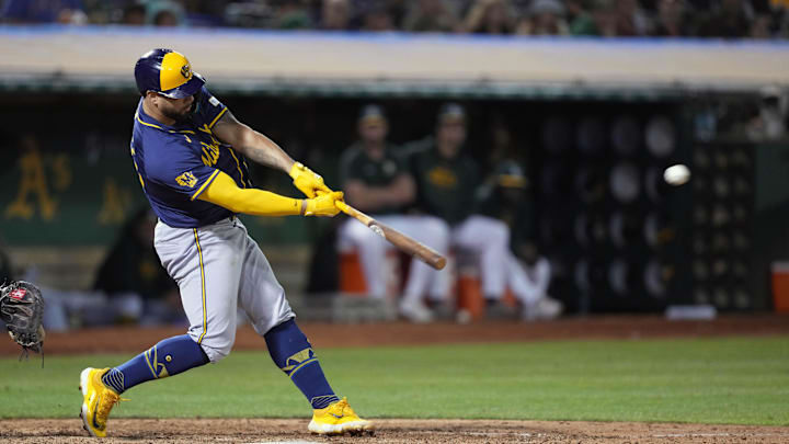 Aug 23, 2024; Oakland, California, USA; Milwaukee Brewers designated hitter Gary Sanchez (99) hits an RBI triple against the Oakland Athletics during the ninth inning at Oakland-Alameda County Coliseum. Mandatory Credit: Darren Yamashita-Imagn Images