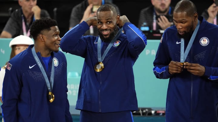 Aug 10, 2024; Paris, France; United States forward LeBron James (6) celebrates with the gold medal after defeating France in the men's basketball gold medal game during the Paris 2024 Olympic Summer Games at Accor Arena. Mandatory Credit: Rob Schumacher-USA TODAY Sports Aug 10, 2024; Paris, France; United States forward LeBron James (6) celebrates with the gold medal after defeating France in the men's basketball gold medal game during the Paris 2024 Olympic Summer Games at Accor Arena. Mandatory Credit: Rob Schumacher-USA TODAY Sports
