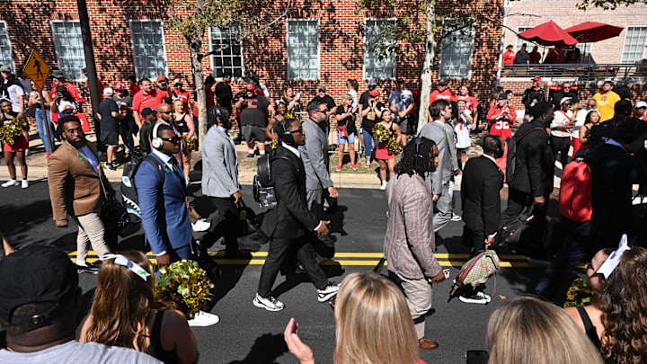 Oct 4, 2025; College Park, Maryland, USA; The Maryland Terrapins football team walks past fans from their bus to the locker room prior to their Family Weekend game against the Washington Huskies at SECU Stadium.
