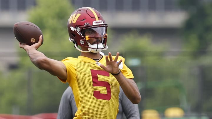 Jun 5, 2024; Ashburn, VA, USA; Washington Commanders quarterback Jayden Daniels (5) prepares to pass a ball during an OTA workout at Commanders Park. Mandatory Credit: Geoff Burke-USA TODAY Sports