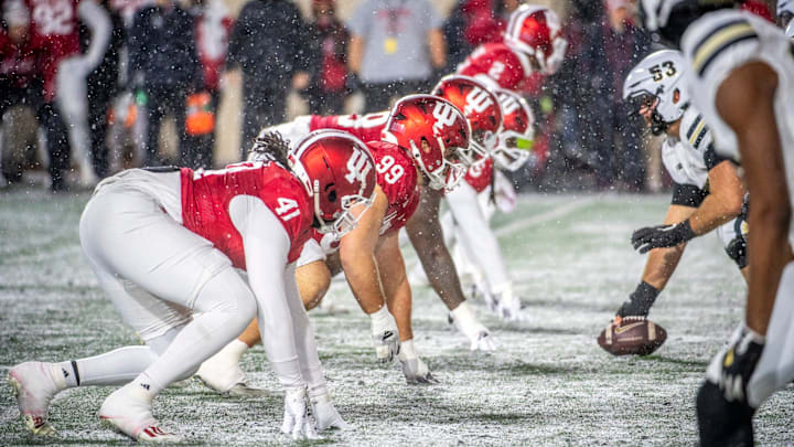Indiana's Lanell Carr Jr. (41), James Carptenter (99) and the Hoosiers line up against Purdue at Memorial Stadium.