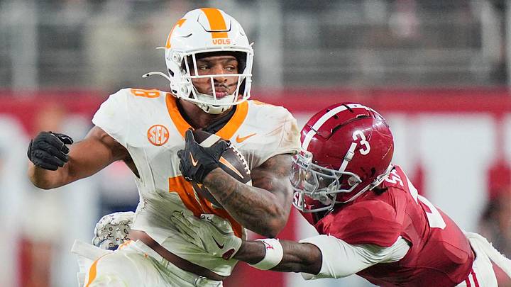 Tennessee linebacker Edwin Spillman (13) is grabbed by Alabama defensive back Keon Sabb (3) during a college football game at Bryant-Denny Stadium in Tuscaloosa, Ala., on Oct. 18, 2025.