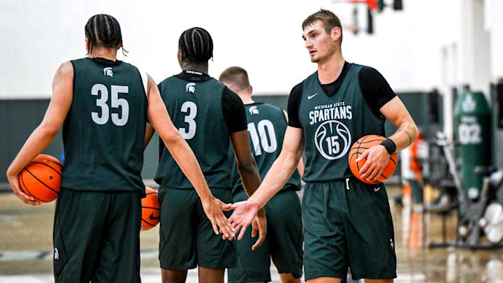 Michigan State's Carson Cooper, right, slaps hands with Jesse McCulloch during the first day of basketball practice on Monday, Sept. 22, 2025, at the Breslin Center in East Lansing.