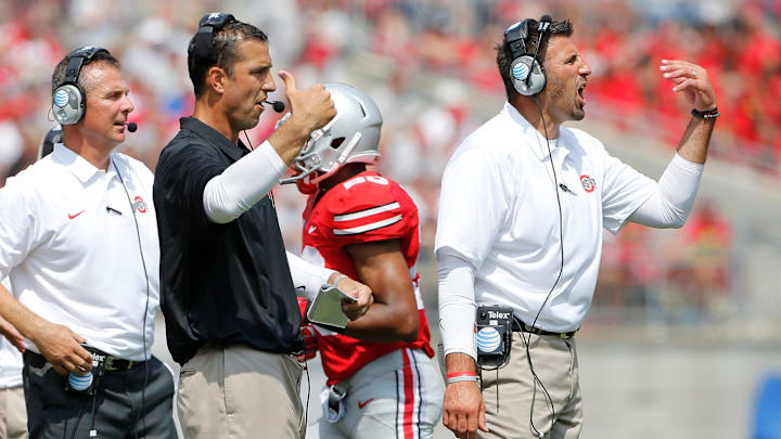 Wisconsin Badgers head coach Luke Fickell (center) has a long relationship with New England Patriots head coach Mike Vrabel (right) from their time at Ohio State