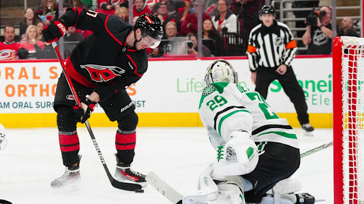 Nov 25, 2024; Raleigh, North Carolina, USA;  Carolina Hurricanes right wing Andrei Svechnikov (37) tries to get the shot away against Dallas Stars goaltender Jake Oettinger (29) during the third period at Lenovo Center. Mandatory Credit: James Guillory-Imagn Images