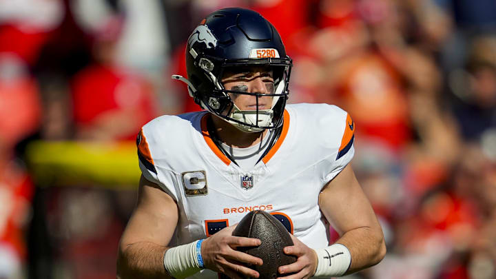 Nov 10, 2024; Kansas City, Missouri, USA; Denver Broncos quarterback Bo Nix (10) rolls out to pass during the second half against the Kansas City Chiefs at GEHA Field at Arrowhead Stadium.