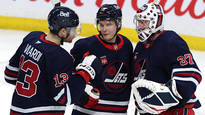 Feb 7, 2025; Winnipeg, Manitoba, CAN; Winnipeg Jets center Gabriel Vilardi (13)m Winnipeg Jets center Vladislav Namestnikov (7) and Winnipeg Jets goaltender Connor Hellebuyck (37) celebrate their victory over the New York Islanders at Canada Life Centre. Mandatory Credit: James Carey Lauder-Imagn Images