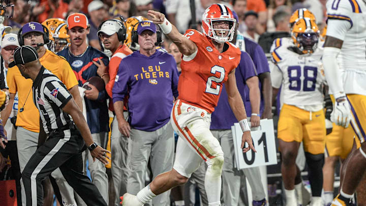 Clemson quarterback Cade Klubnik (2) reacts near LSU head coach Brian Kelly on the sidelines after getting a first down