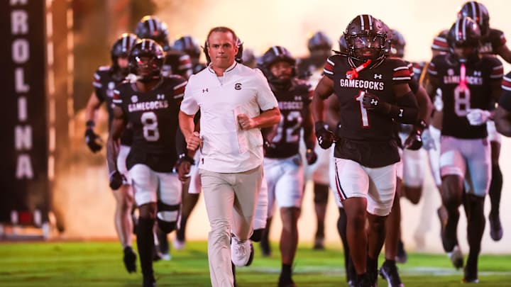 Sep 27, 2025; Columbia, South Carolina, USA; South Carolina Gamecocks head coach Shane Beamer leads his team onto the field during the Gamecocks 2001 entrance before their game against the Kentucky Wildcats at Williams-Brice Stadium. Mandatory Credit: Jeff Blake-Imagn Images