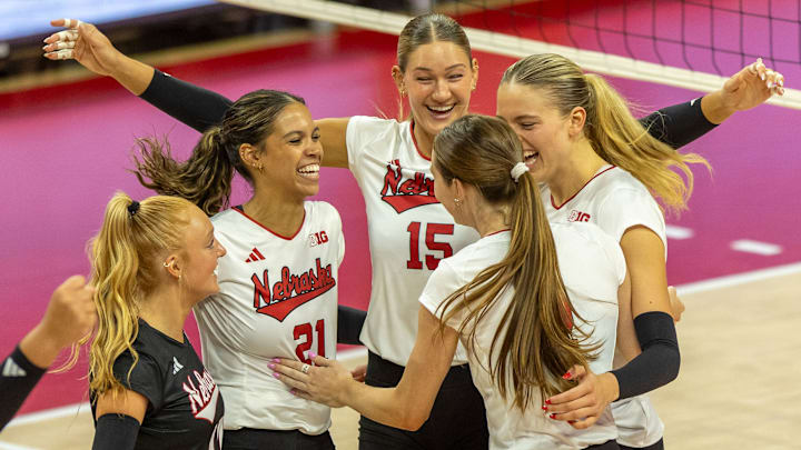 Members of the white team celebrate a point during the Red-White Scrimmage on Saturday.