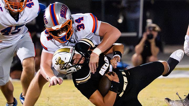 Bolles Bulldogs defensive lineman Asher Ghioto (34) tackles Oakleaf Knights Kashawn Murphy (90) in the second quarter Friday September 19, 2025 at Oakleaf High School in Oakleaf Plantation, Florida. The Bolles Bulldogs are 3-1 while the Oakleaf Knights are 4-0. Bolles lead 21-6 at the half. [Doug Engle/Florida Times-Union]