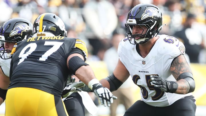 Nov 17, 2024; Pittsburgh, Pennsylvania, USA;  Baltimore Ravens guard Patrick Mekari (65) blocks at the line of scrimmage against Pittsburgh Steelers defensive tackle Cameron Heyward (97) during the first quarter at Acrisure Stadium. Mandatory Credit: Charles LeClaire-Imagn Images