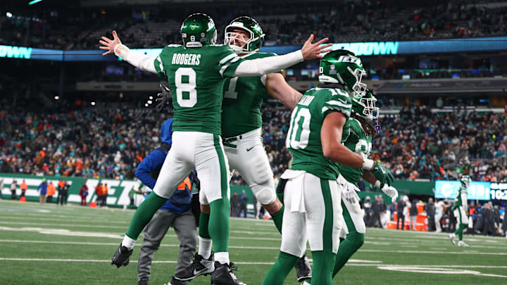Jan 5, 2025; East Rutherford, New Jersey, USA; New York Jets quarterback Aaron Rodgers (8) celebrates his touchdown pass to New York Jets wide receiver Davante Adams (17) (not pictured) during the fourth quarter of their game against the Miami Dolphins at MetLife Stadium. Mandatory Credit: Ed Mulholland-Imagn Images Jan 5, 2025; East Rutherford, New Jersey, USA; New York Jets quarterback Aaron Rodgers (8) celebrates his touchdown pass to New York Jets wide receiver Davante Adams (17) (not pictured) during the fourth quarter of their game against the Miami Dolphins at MetLife Stadium. Mandatory Credit: Ed Mulholland-Imagn Images