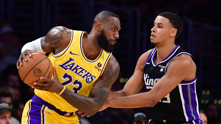 Mar 6, 2024; Los Angeles, California, USA;  Los Angeles Lakers forward LeBron James (23) moves the ball against Sacramento Kings forward Keegan Murray (13) during the first half at Crypto.com Arena.