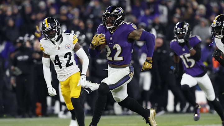 Jan 11, 2025; Baltimore, Maryland, USA; Baltimore Ravens running back Derrick Henry (22) runs for a touchdown against Pittsburgh Steelers cornerback James Pierre (42) in the third quarter in an AFC wild card game at M&T Bank Stadium. Mandatory Credit: Geoff Burke-Imagn Images