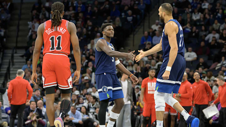 Feb 5, 2025; Minneapolis, Minnesota, USA; Minnesota Timberwolves guard Anthony Edwards (5) congratulates center Rudy Gobert (27) on his dunk as Chicago Bulls guard Ayo Dosunmu (11) walks to his bench after a timeout was called during the fourth quarter at Target Center. Mandatory Credit: Nick Wosika-Imagn Images
