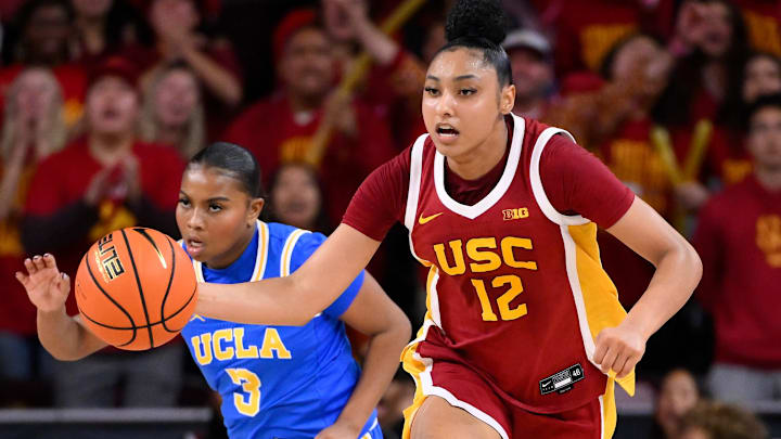 Feb 13, 2025; Los Angeles, California, USA; USC Trojans guard JuJu Watkins (12) dribbles past UCLA Bruins guard Londynn Jones (3) during an NCAA basketball game at Galen Center. Mandatory Credit: Robert Hanashiro-Imagn Images
