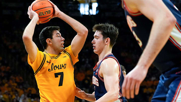 Iowa forward Cooper Koch (8) looks to pass the basketball against Illinois forward David Mirkovic (0) Jan. 11, 2026 at Carver-Hawkeye Arena in Iowa City, Iowa.