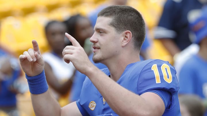 Aug 31, 2024; Pittsburgh, Pennsylvania, USA;  Pittsburgh Panthers quarterback Eli Holstein (10) leads the band in the playing of the PITT Alma Mater after defeating the Kent State Golden Flashes at Acrisure Stadium. Pittsburgh won 55-24.Mandatory Credit: Charles LeClaire-Imagn Images