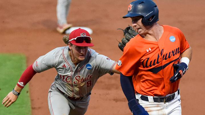 NC State Wolfpack's Justin DeCriscio (8) tags out Auburn Tigers' Cade Belyeu (14) in a rundown between second and first bases during the NCAA Regional Baseball Tournament at Plainsman Park in Auburn, Ala., on Sunday June 1, 2025. NC State Wolfpack's Justin DeCriscio (8) tags out Auburn Tigers' Cade Belyeu (14) in a rundown between second and first bases during the NCAA Regional Baseball Tournament at Plainsman Park in Auburn, Ala., on Sunday June 1, 2025.