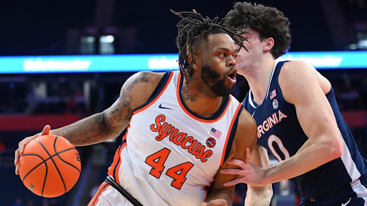 Syracuse Orange center Eddie Lampkin Jr. (44) drives against Virginia Cavaliers forward Blake Buchanan (0) during the first half at the JMA Wireless Dome.