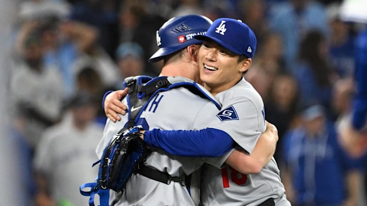 Los Angeles Dodgers pitcher Yoshinobu Yamamoto (18) and catcher Will Smith (16) 