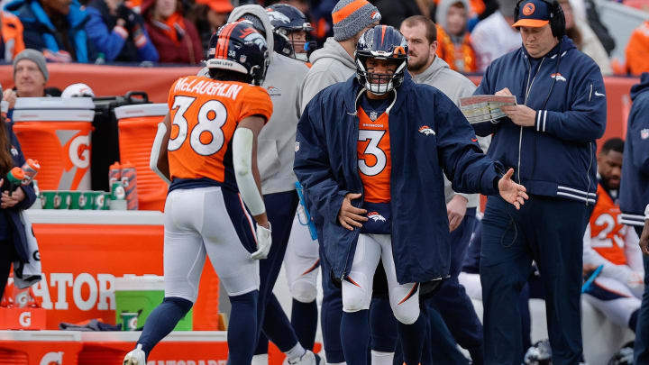 Dec 31, 2023; Denver, Colorado, USA; Denver Broncos quarterback Russell Wilson (3) reacts with running back Jaleel McLaughlin (38) after a play in the second quarter against the Los Angeles Chargers at Empower Field at Mile High. Mandatory Credit: Isaiah J. Downing-USA TODAY Sports