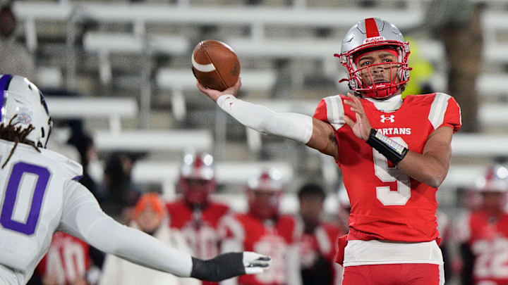 Dec 6, 2024; Birmingham, AL, USA; Saraland's KJ Lacey (9) thows a pass as he is pressured by a Parker defender at Protective Stadium in the 6A State Championship game. Parker defeated Saraland 28-17.