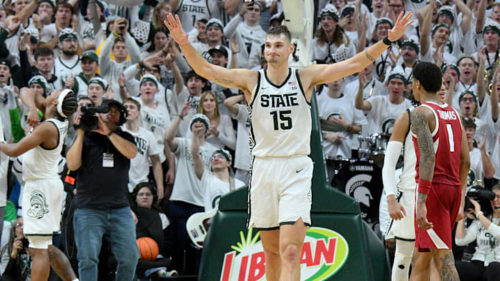 Nov 8, 2025; East Lansing, Michigan, USA;  Michigan State Spartans center Carson Cooper (15) starts the celebration as his team beats Arkansas at Jack Breslin Student Events Center. Mandatory Credit: Dale Young-Imagn Images